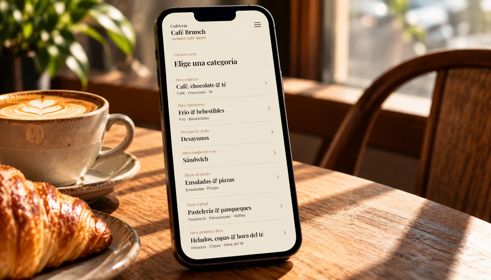 Celular con la carta digital de Café Brunch, que muestra categorías como desayunos, sándwich, ensaladas y pastelería